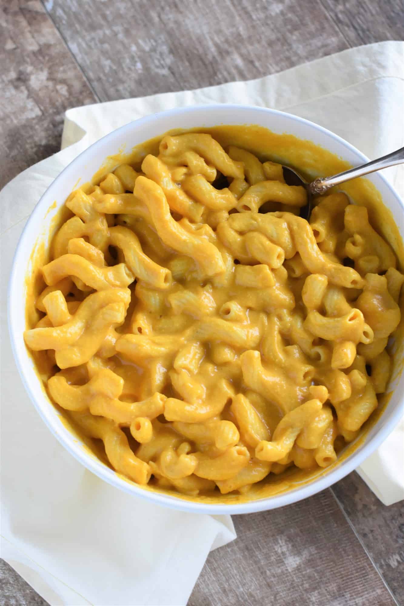 overhead of mac and cheese in a serving bowl with a spoon in it