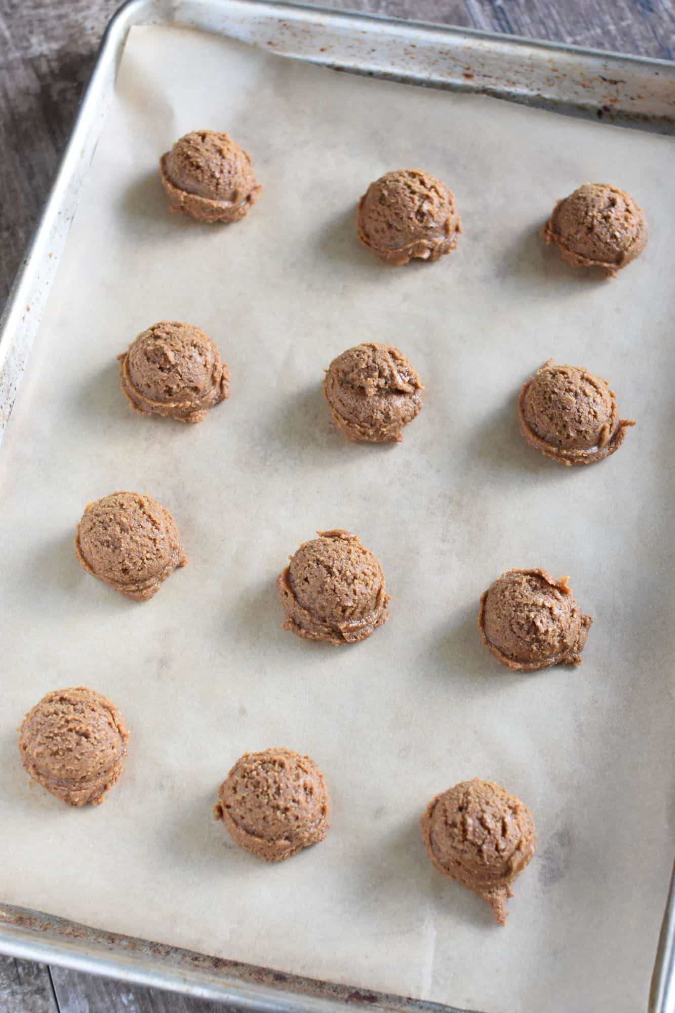 scooped cookie dough on baking sheet