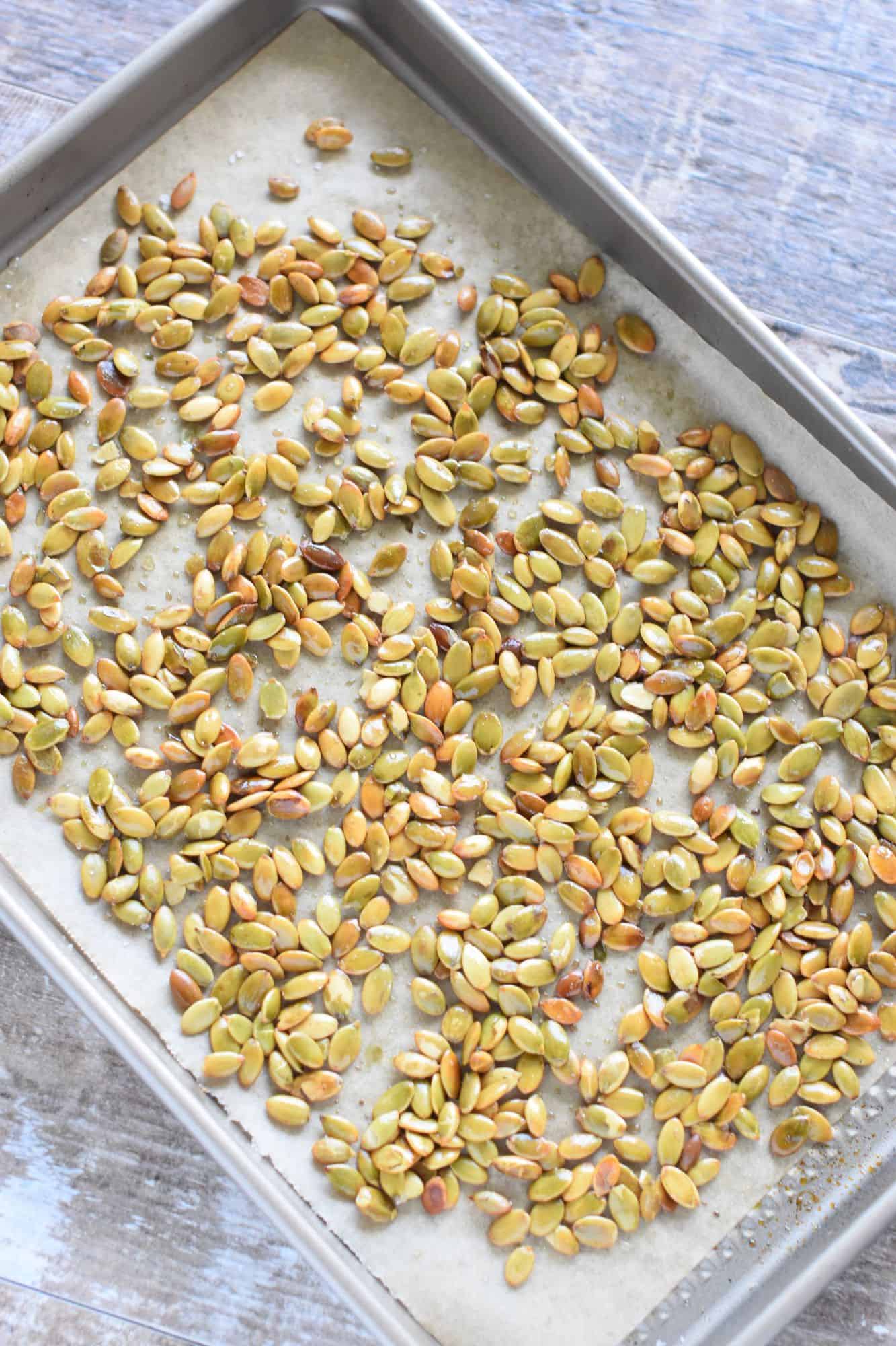 roasted pepitas on the baking sheet after being cooked