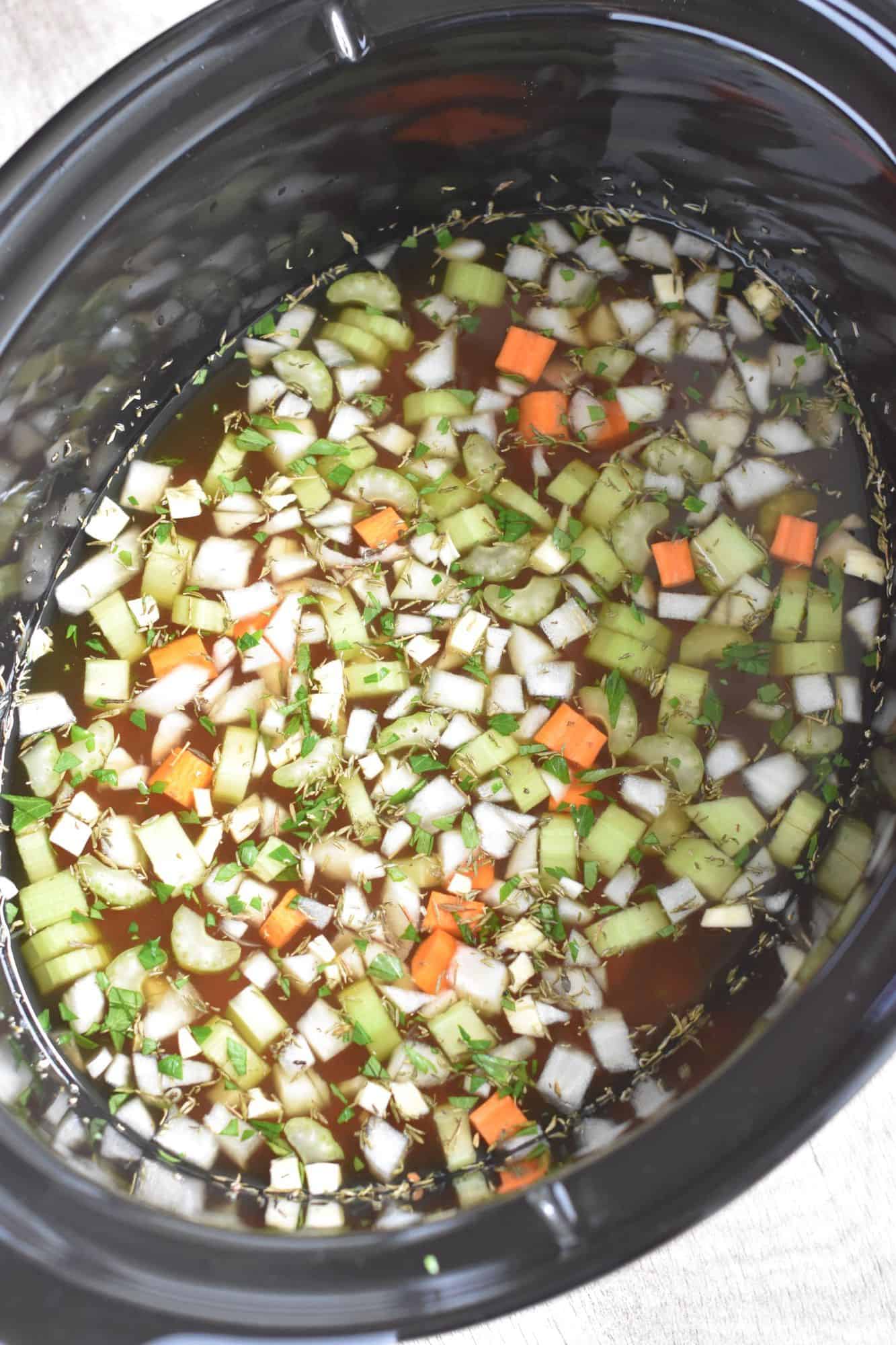 broth and seasonings added to slow cooker