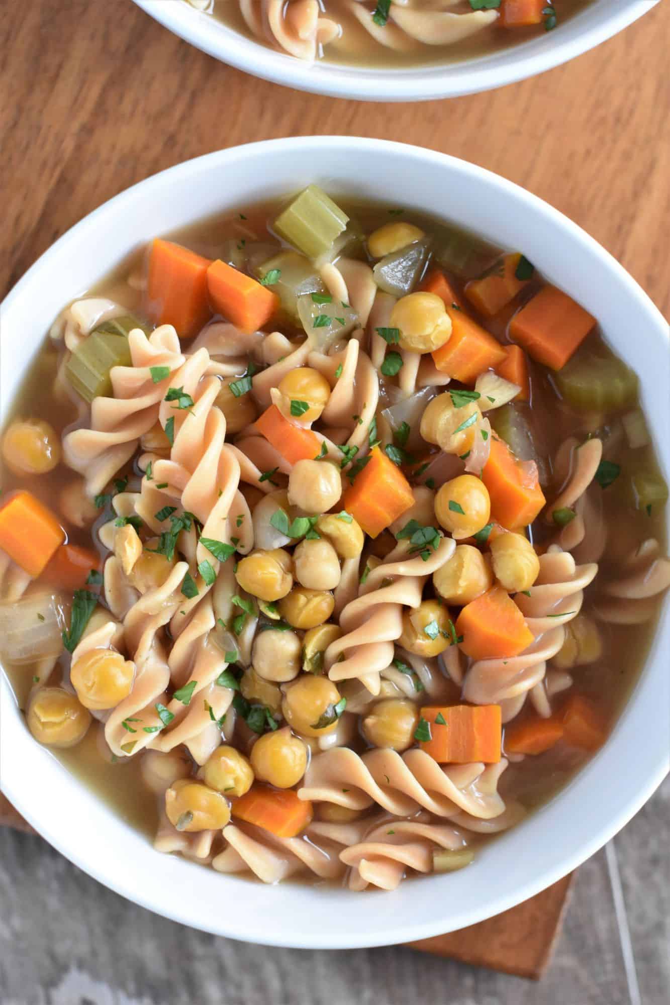 closeup overhead of soup in a white bowl with part of another one in view