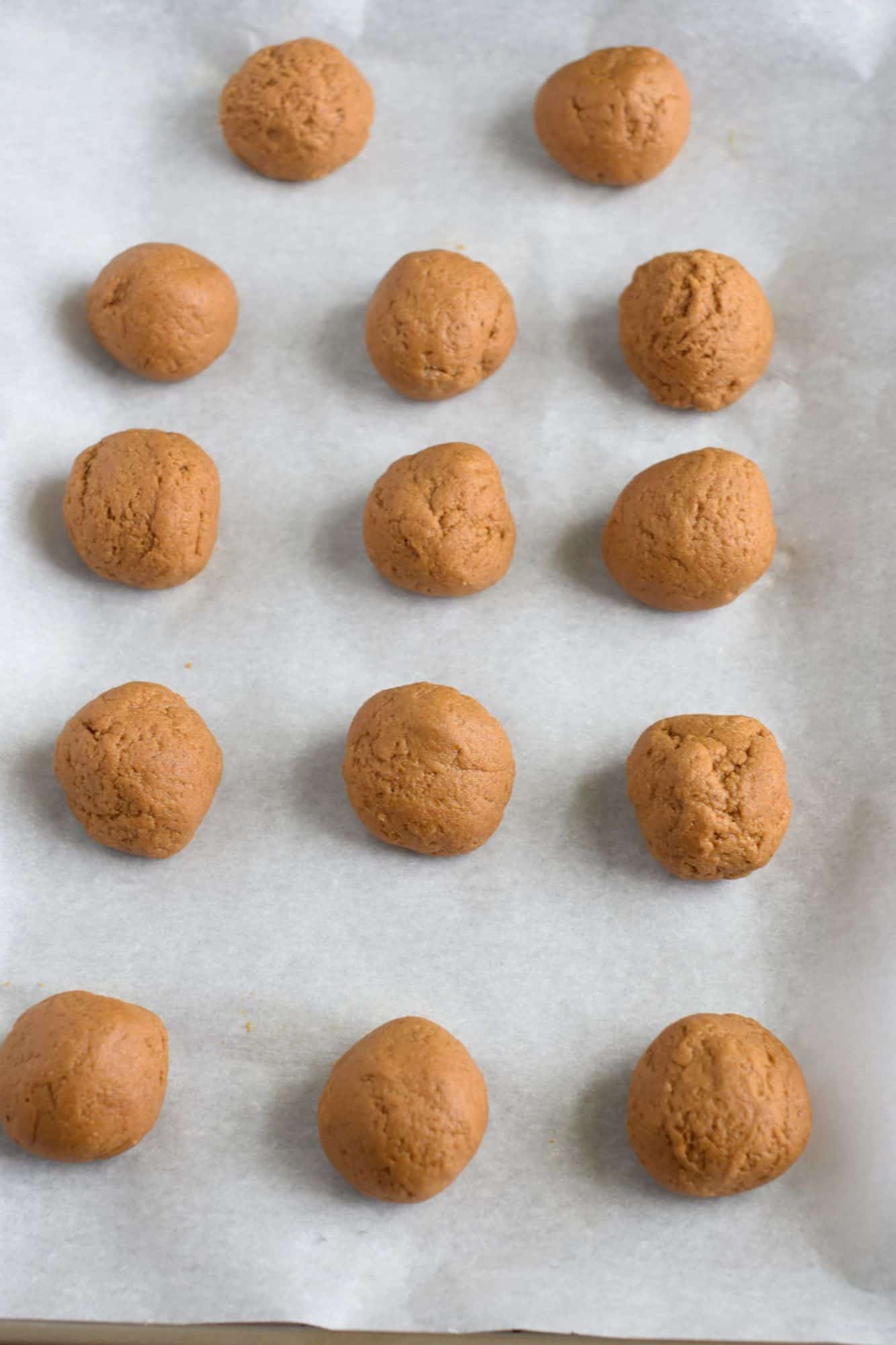 dough balls on a parchment-lined cookie sheet