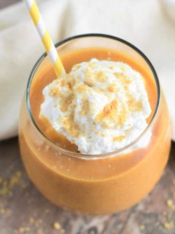 overhead of smoothie with non-dairy whip, crumbled grahams and a straw