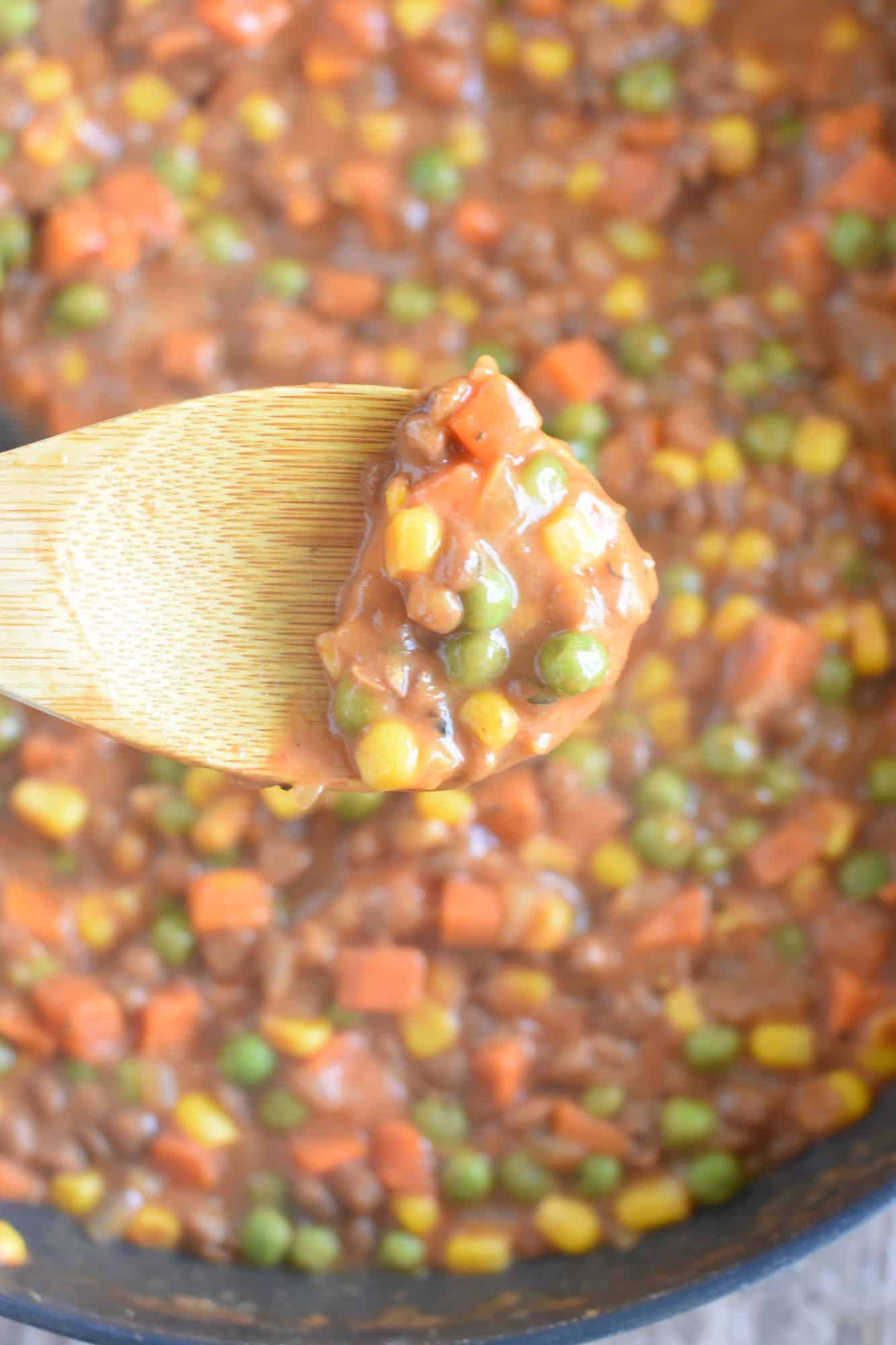 wooden spoon with some of the filling mixture on it to show consistency