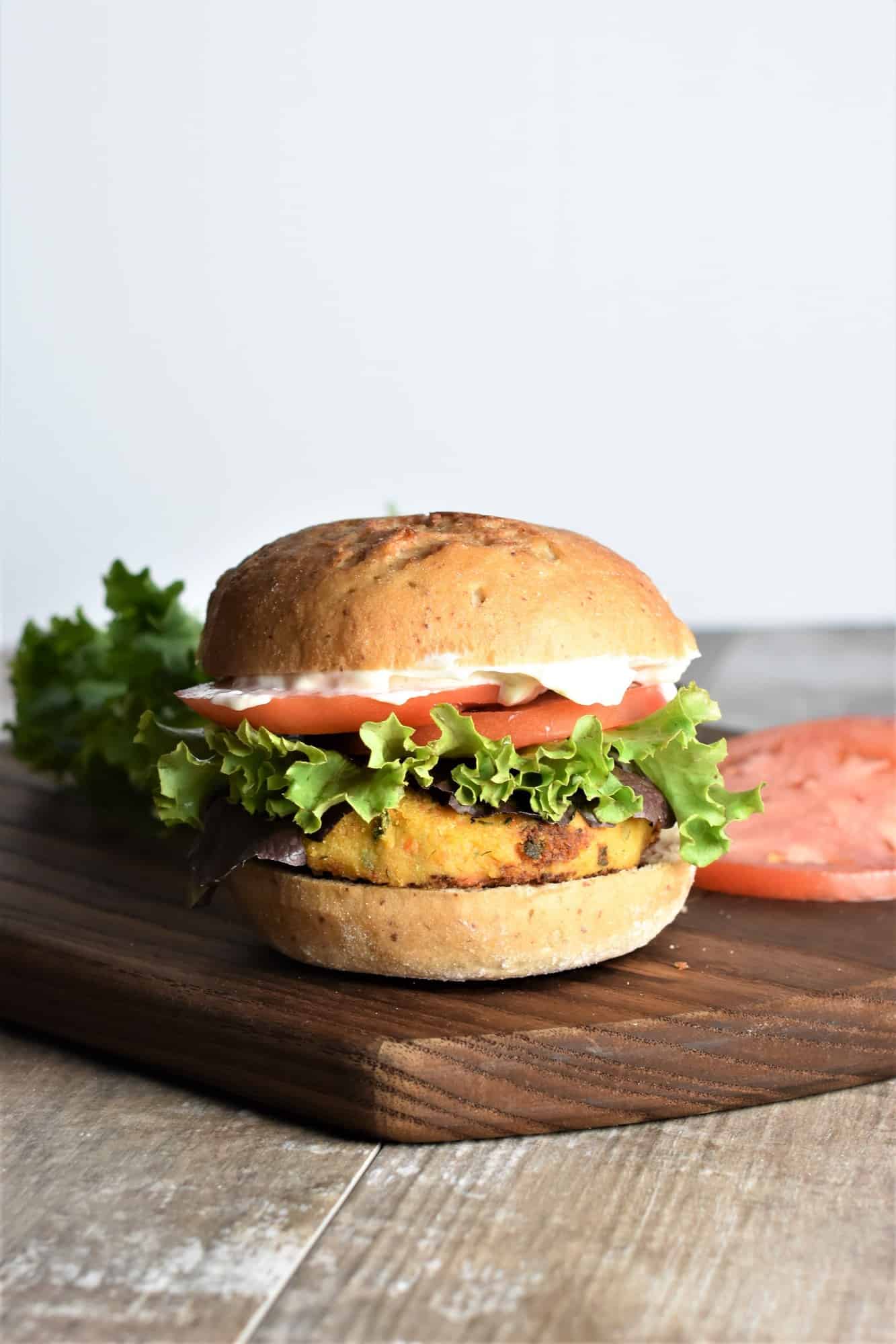 front view of burger on a wooden board