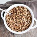 overhead of seeds in white bowl with spoon