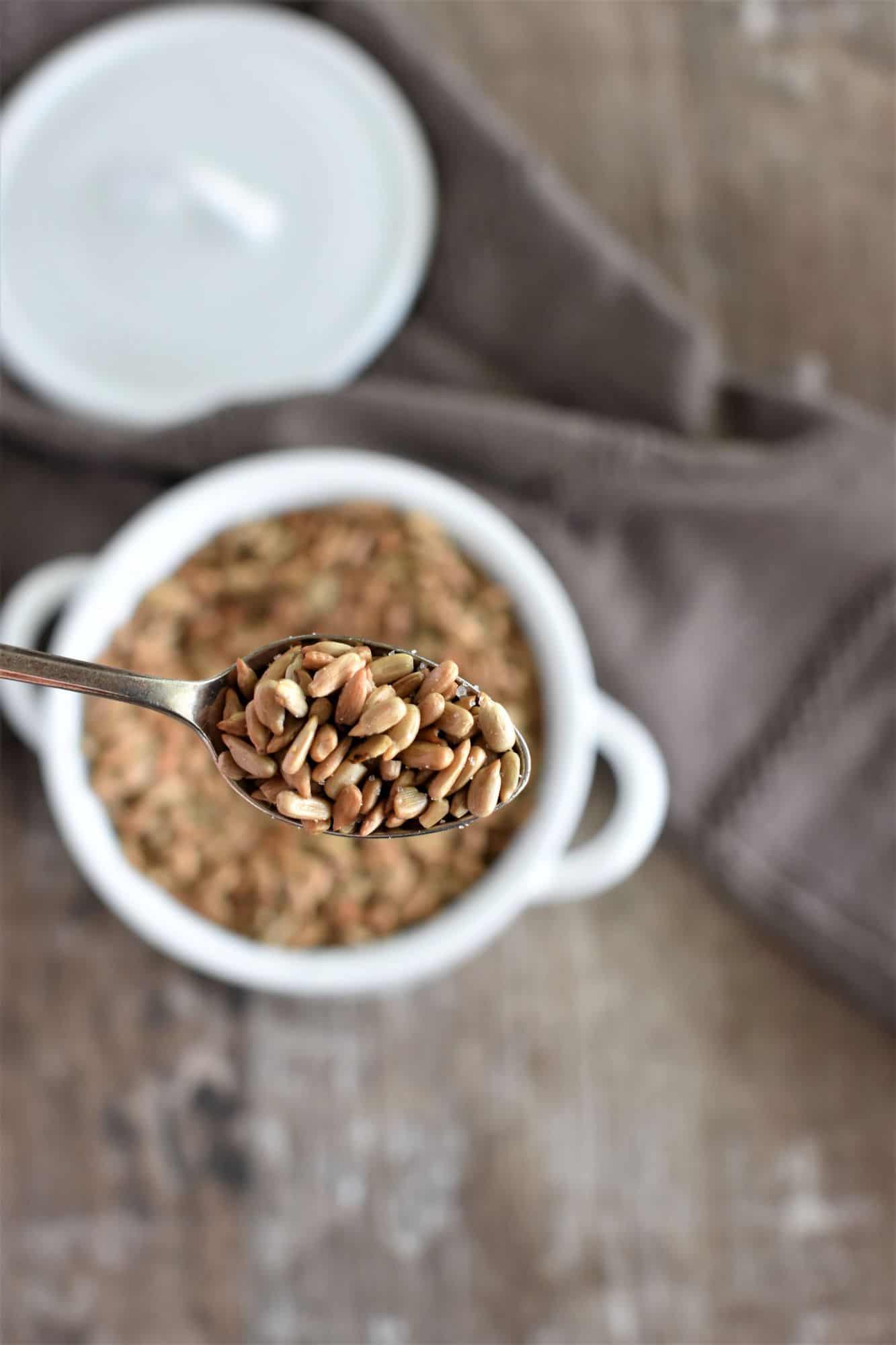 spoon of seeds hovering over bowl of them