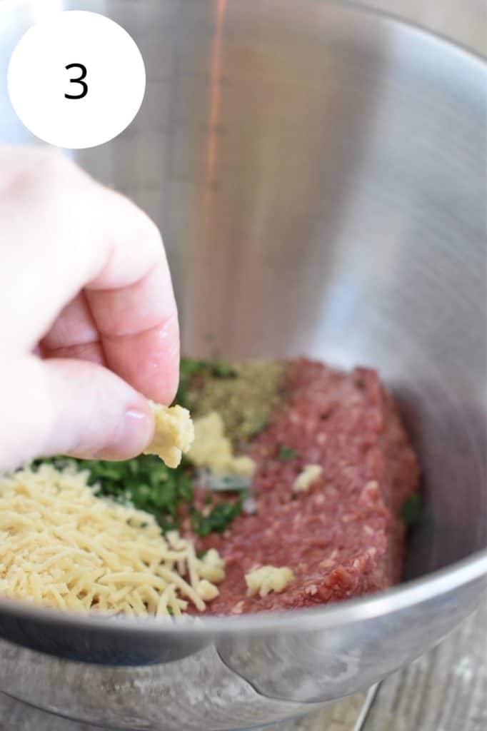 crumbling milk-coated bread into the meatballs mixture