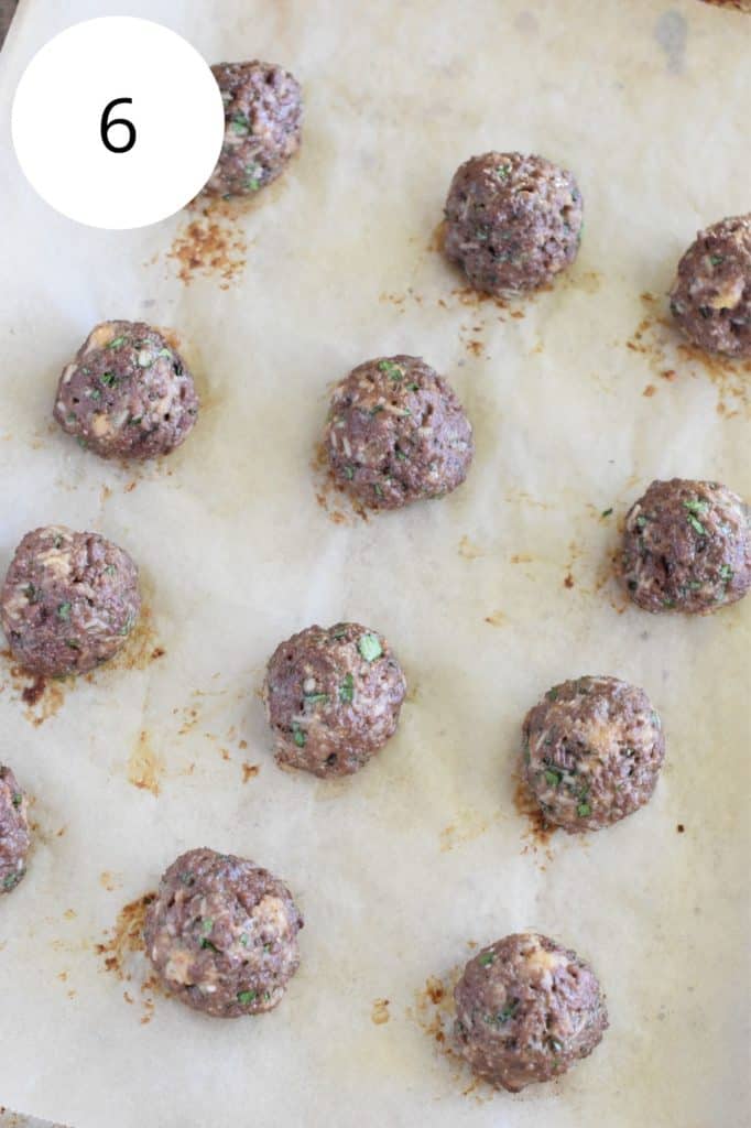 cooked meatballs on baking sheet