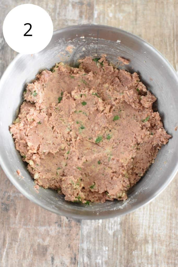 ingredients for vegan meatballs in mixing bowl after being mixed together