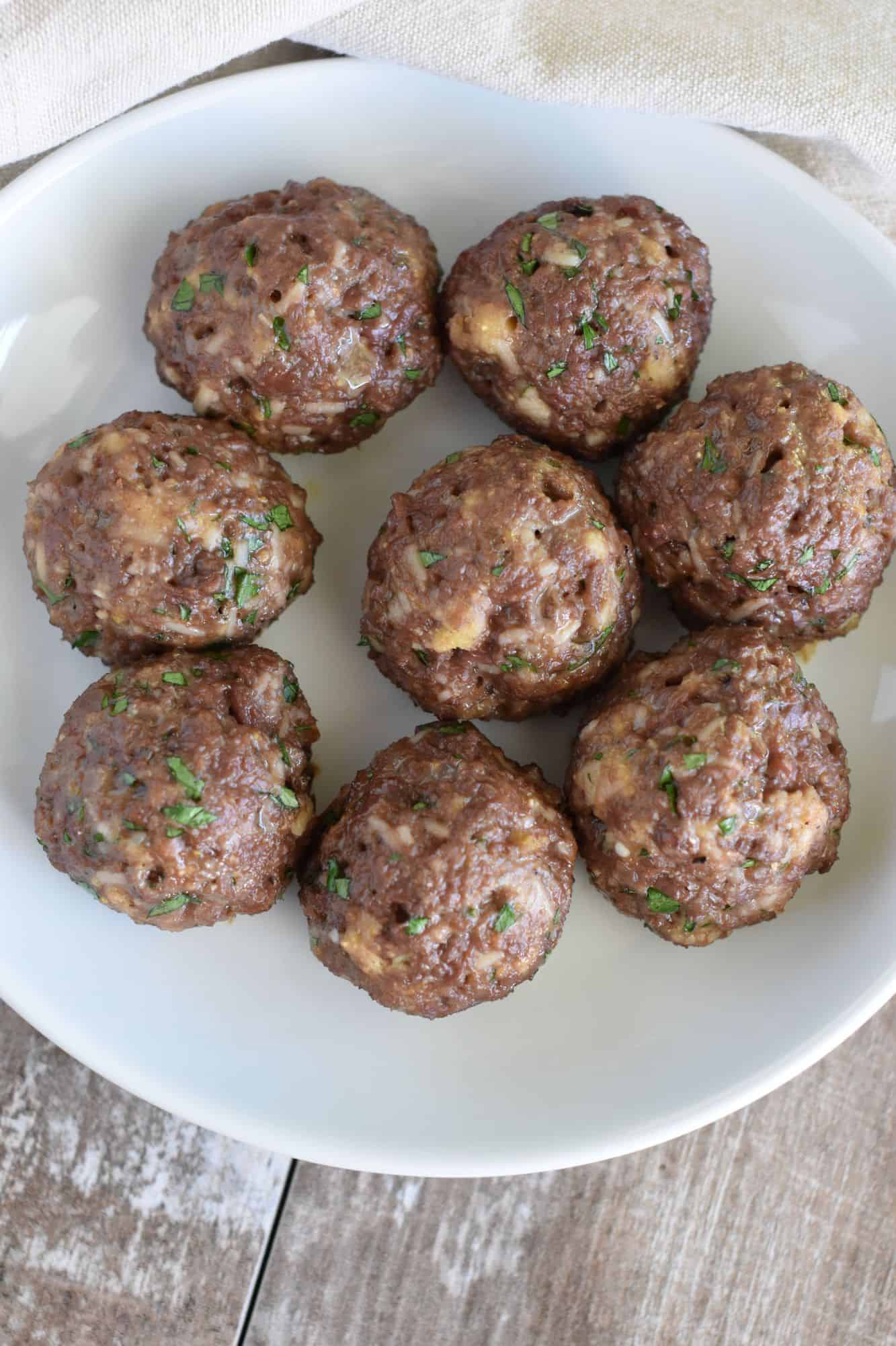 overhead of meatballs on a white plate with no sauce