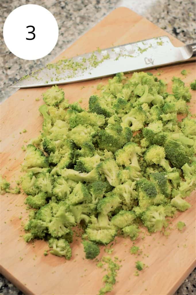 chopped broccoli florets on wooden cutting board