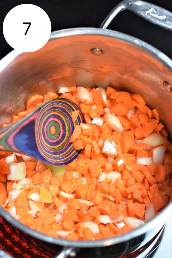 sautéing onion and carrots in pot