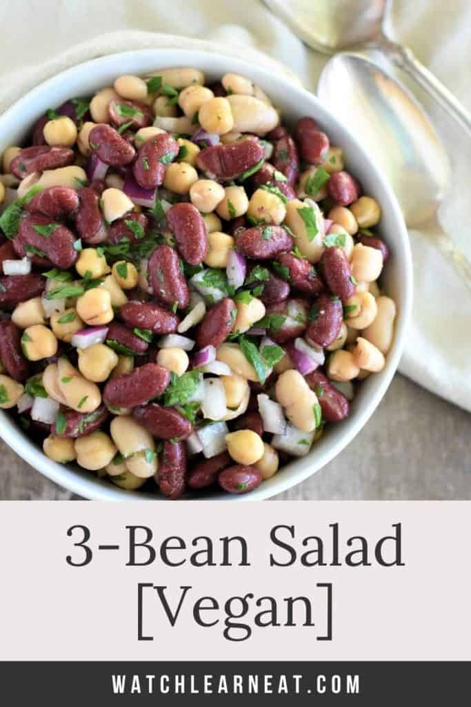 pin showing 3 bean salad in white bowl with spoons next to it