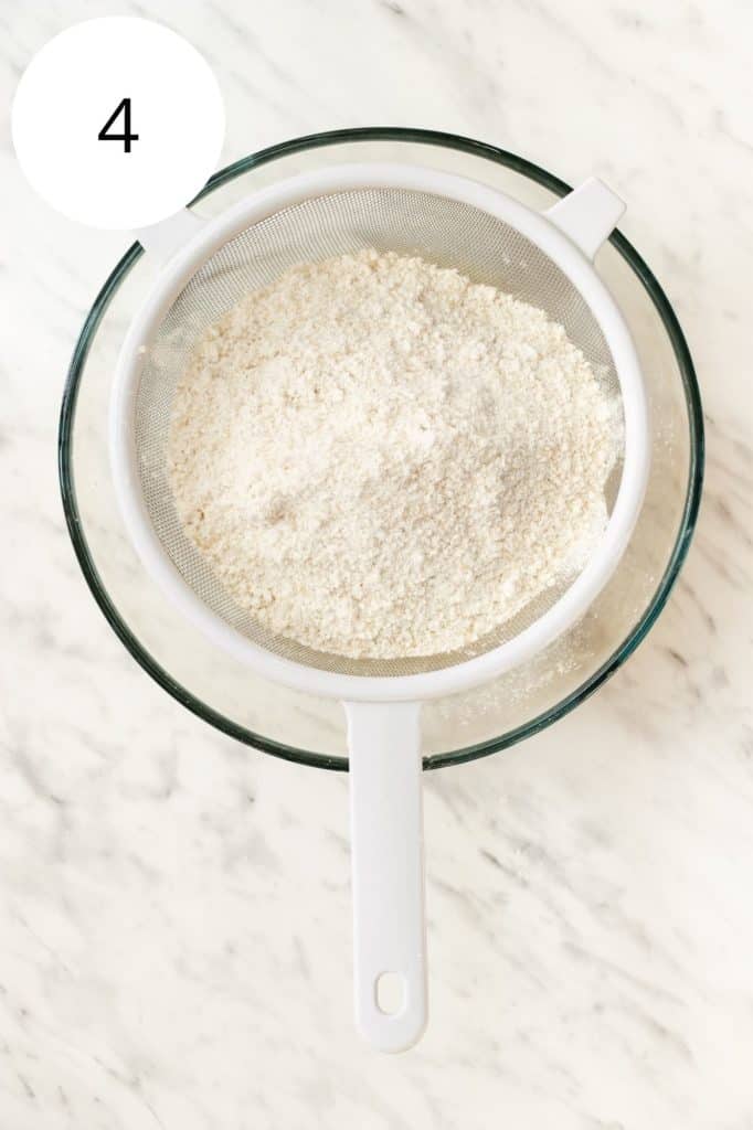 sifting dry ingredients into mixing bowl