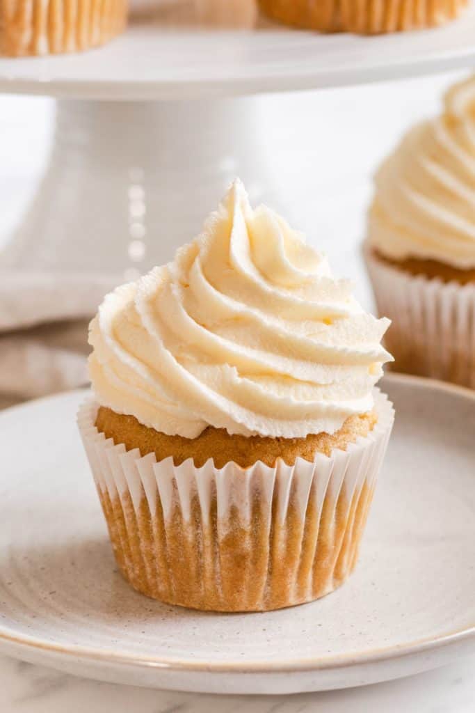 close-up of one frosted cupcake on a plate