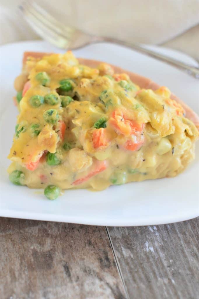 right side view of slice of pot pie on a white plate