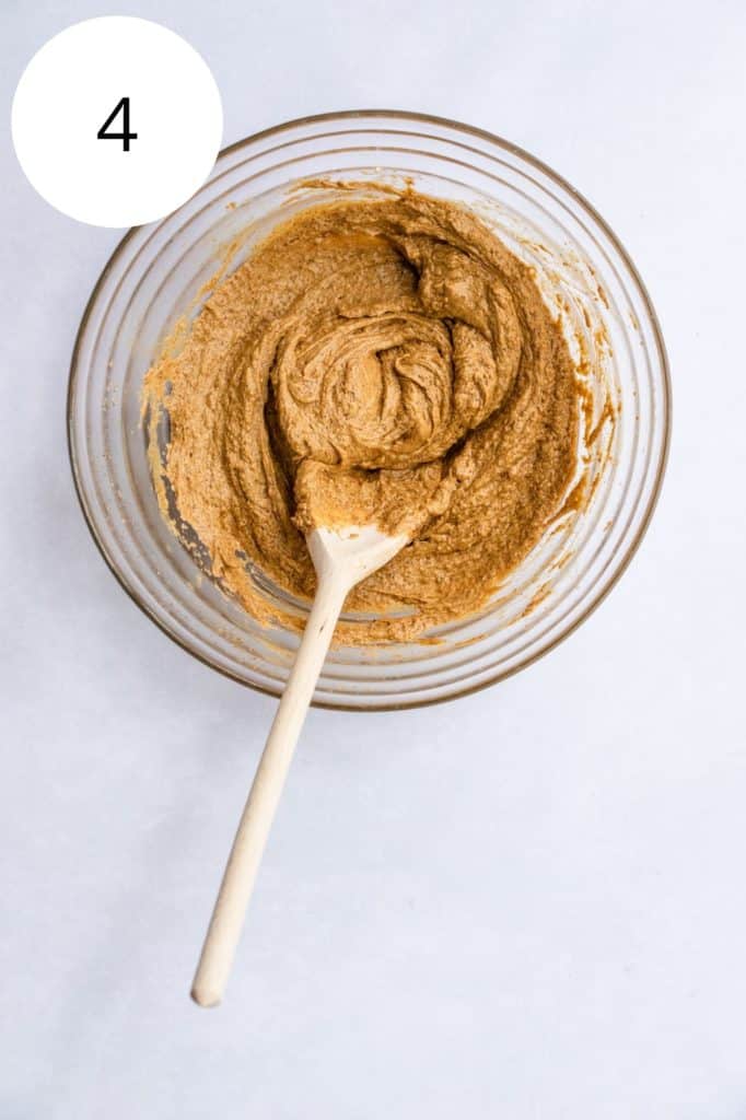 wet ingredients combined in mixing bowl with wooden spoon