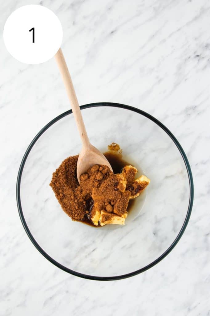 vegan butter, coconut sugar, aquafaba and vanilla in a mixing bowl with a wooden spoon