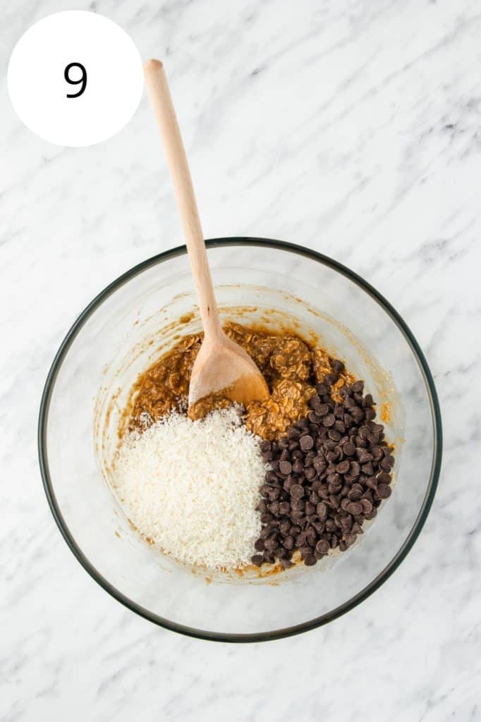 Coconut and chocolate chips added to the cookie dough mixture in the mixing bowl