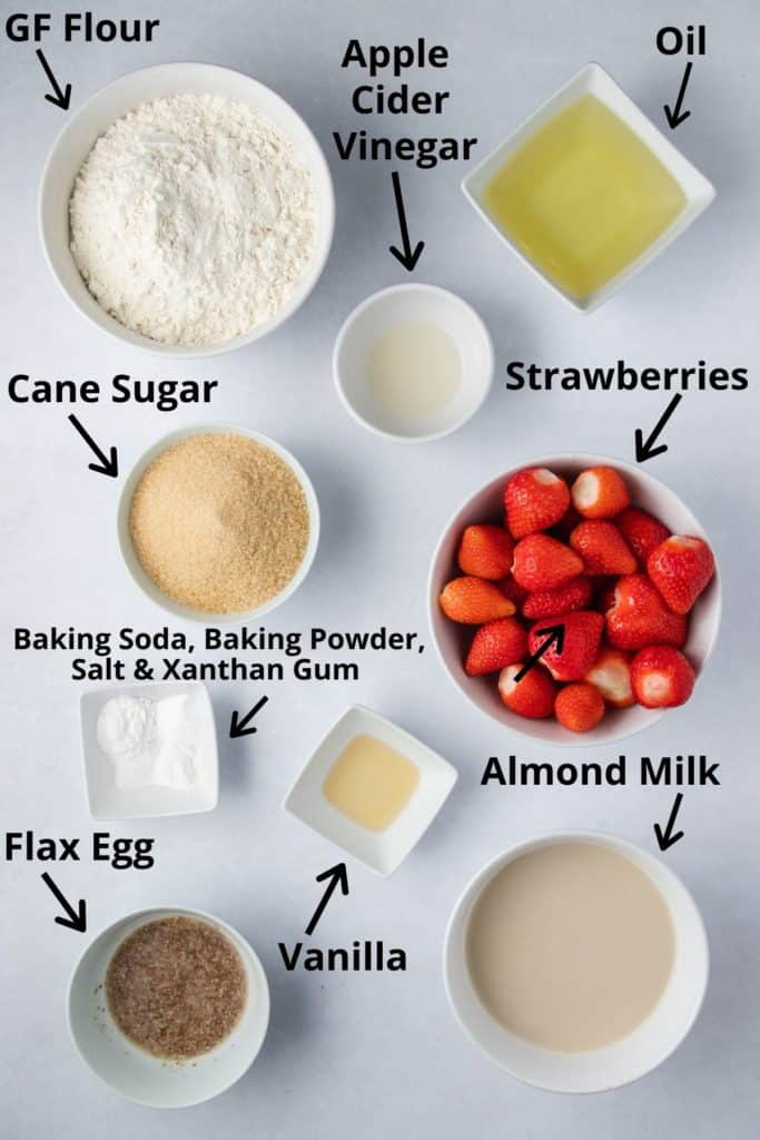 overhead of ingredients for cake in white bowls with text labels