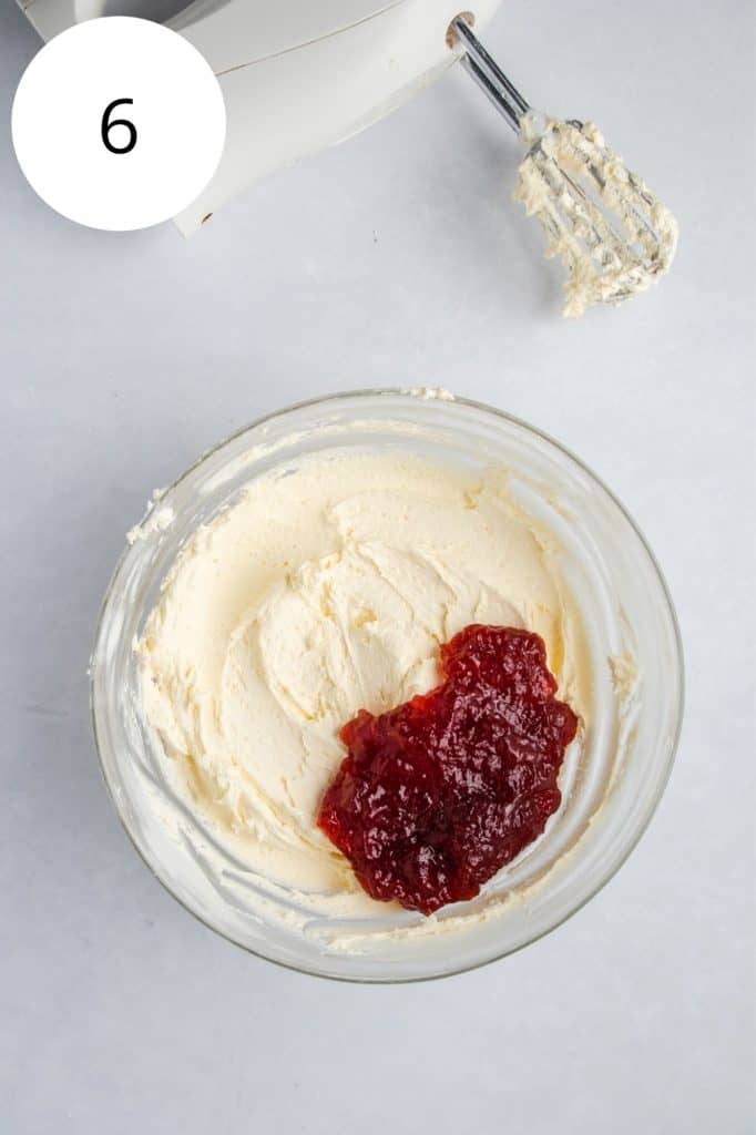 strawberry preserves added to the frosting in the mixing bowl