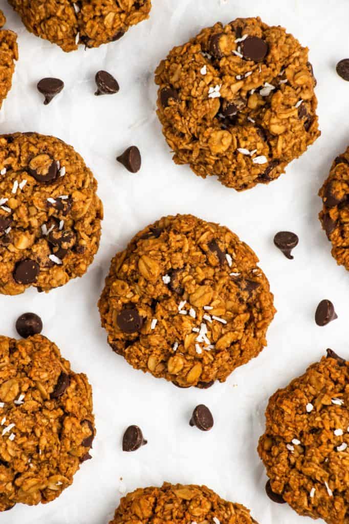 cookies on parchment with chocolate chips around them