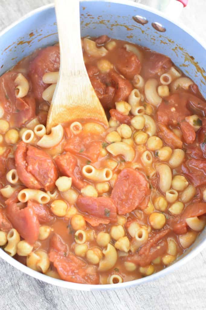 soup in pot after cooking with wooden spoon in it