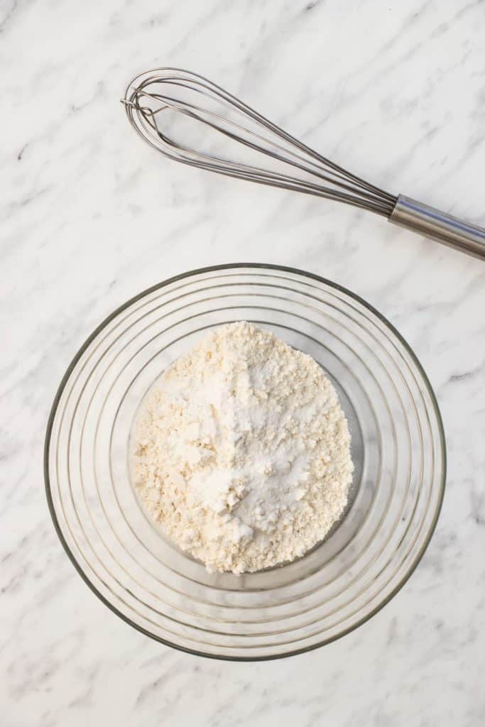 dry ingredients in a bowl with whisk behind it