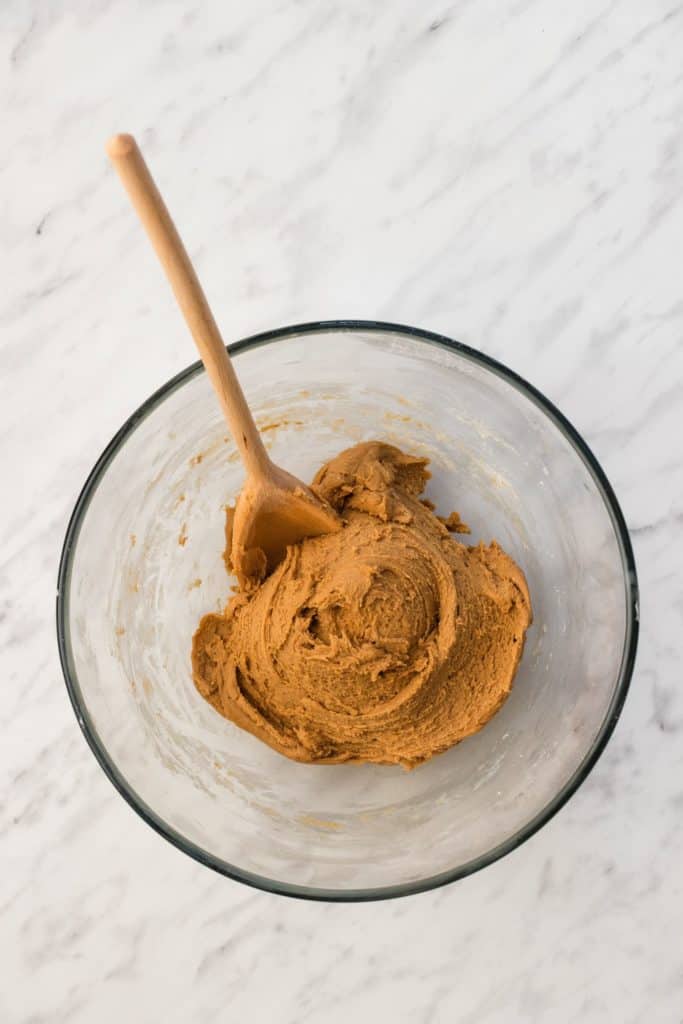 cookie dough after dry and wet ingredients were combined with wooden spoon in the bowl