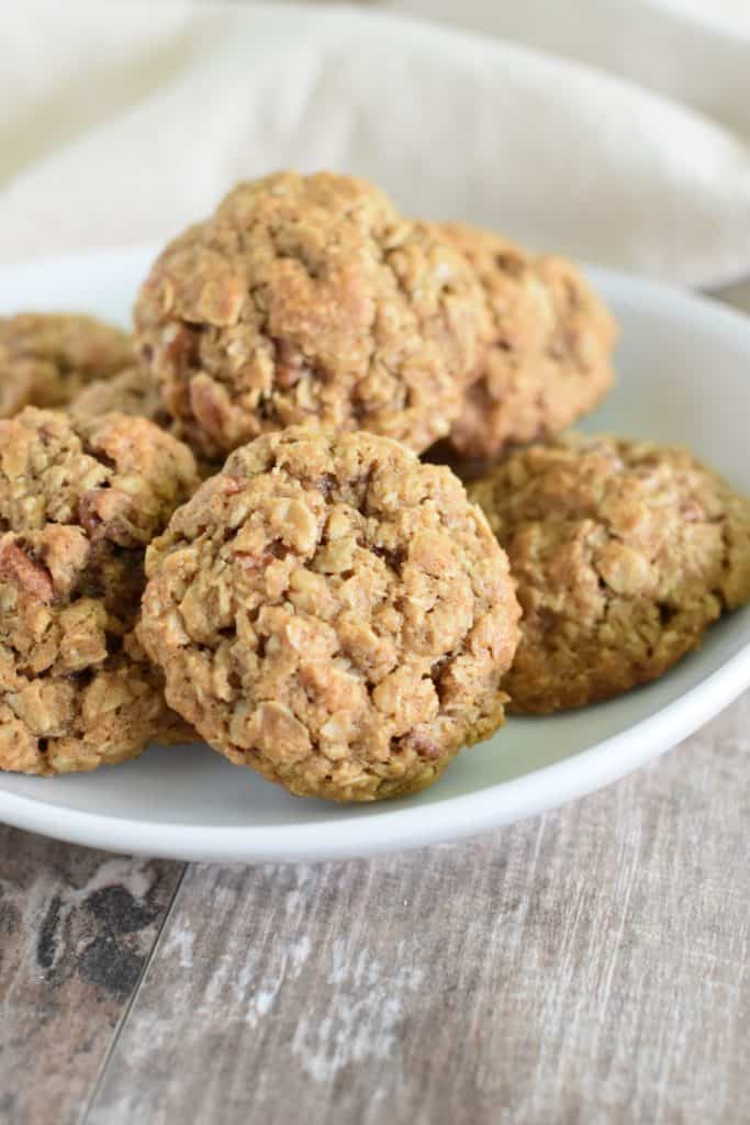 front view of oatmeal coconut pecan cookies on a white plate