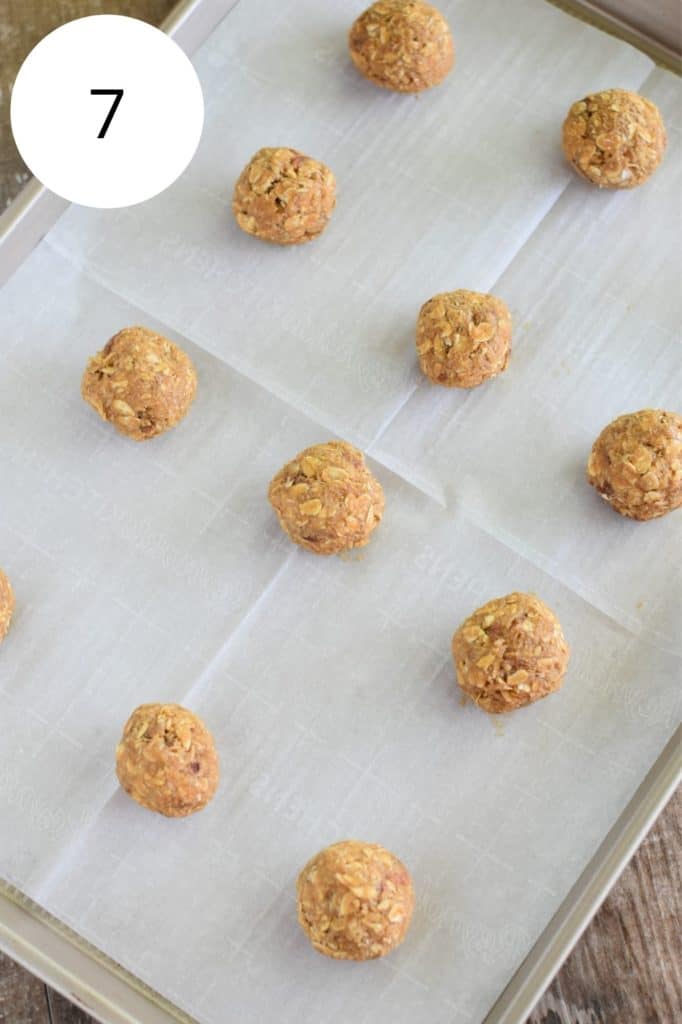 oatmeal coconut pecan cookie dough balls on baking sheet with parchment paper