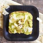 close-up of slice of avocado toast with Parmesan cheese