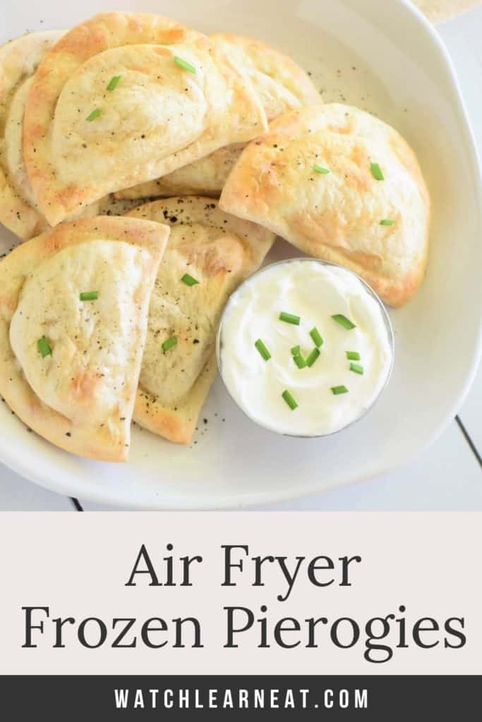 pin showing pierogies on white plate with side of sour cream