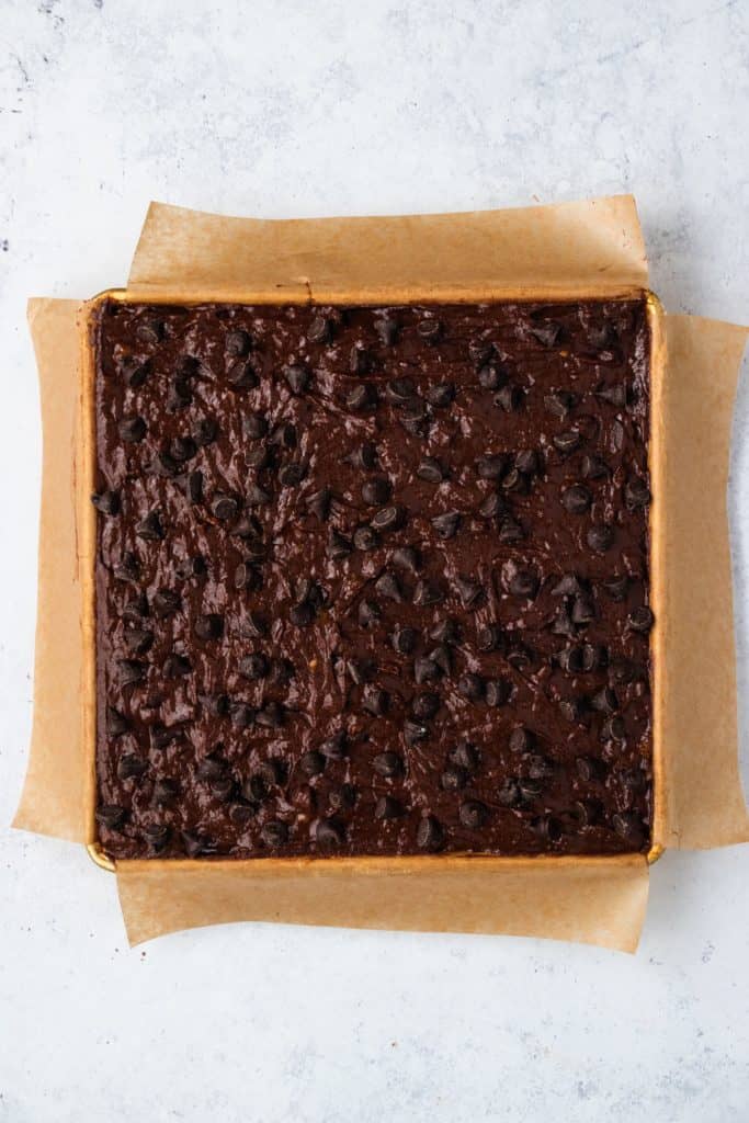 brownie batter in pan after chips added to top