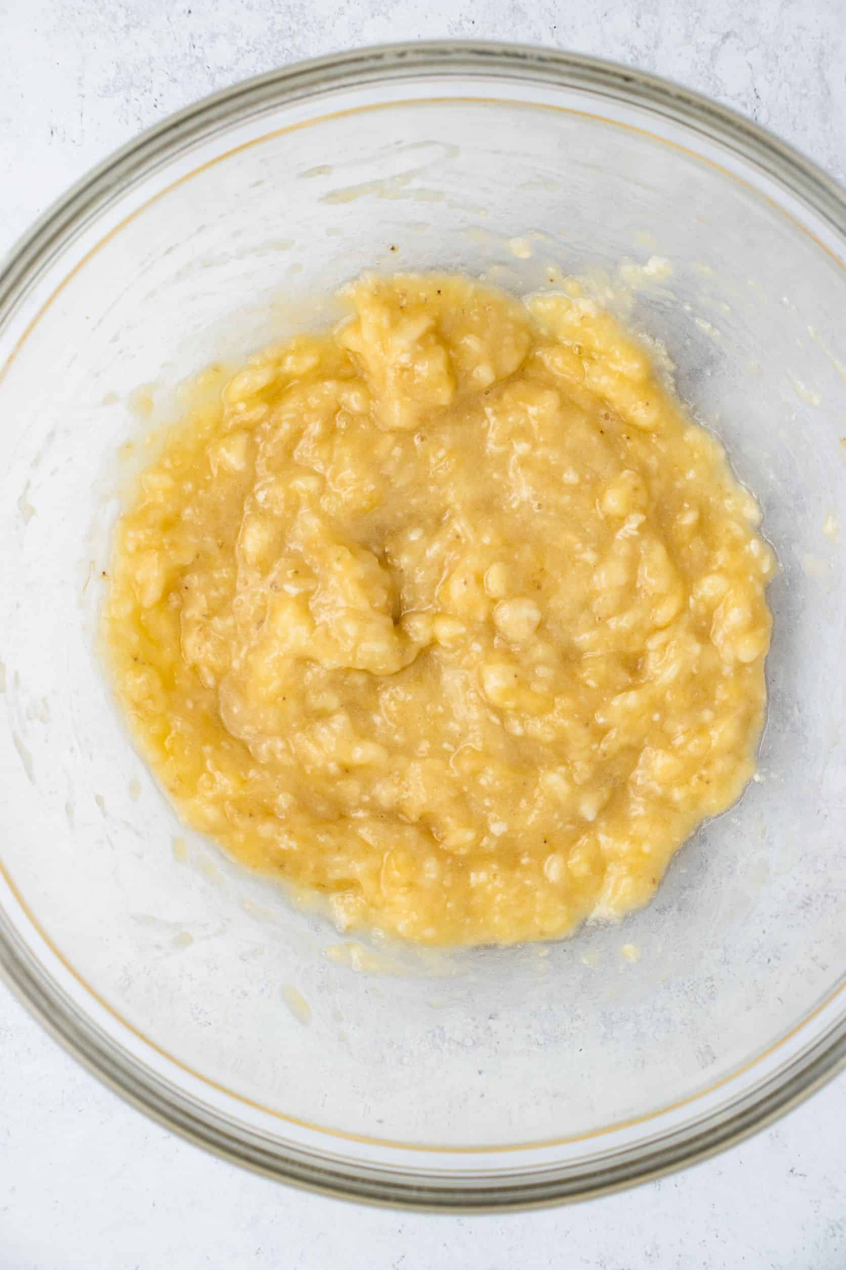 overhead of mashed bananas in mixing bowl