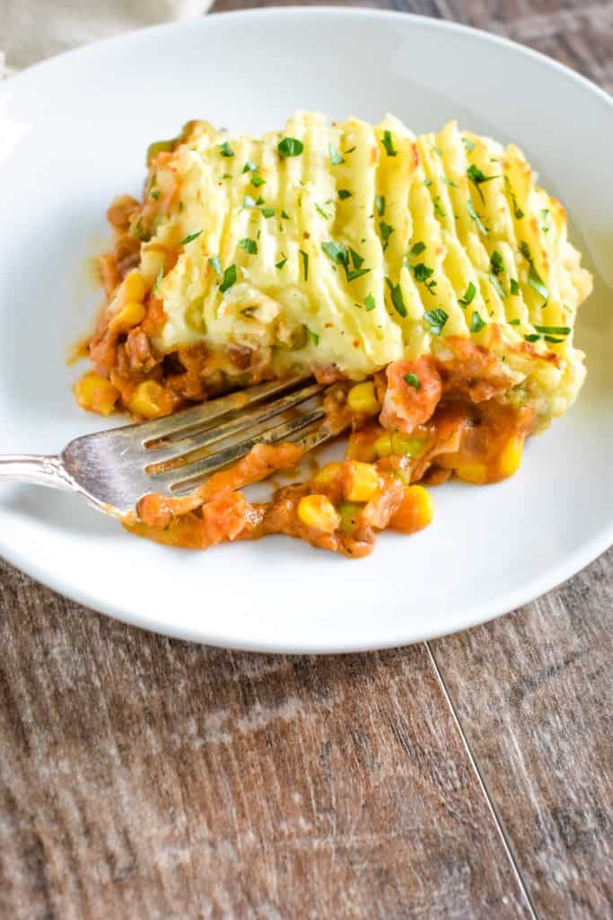 front view of shepherd's pie with a fork going into the front