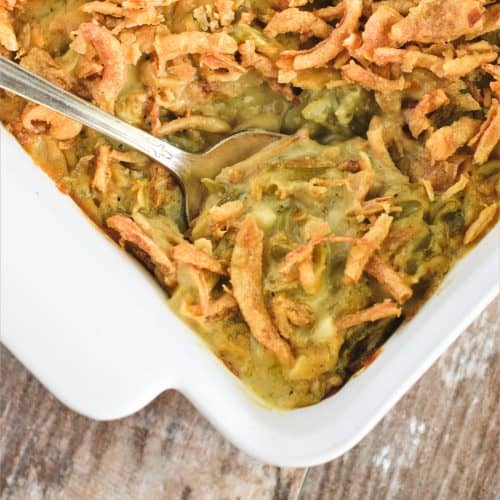 close-up of spoon scooping out casserole from the baking dish