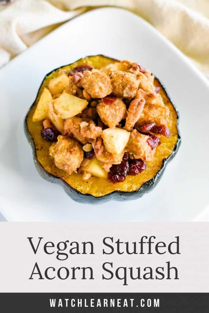 pin showing overhead of serving of stuffed acorn squash on white plate with text title overlay