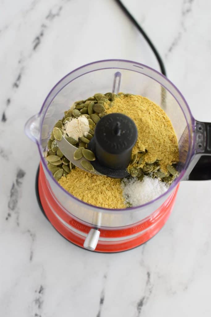 pumpkin seed Parmesan ingredients in a food chopper before being combined