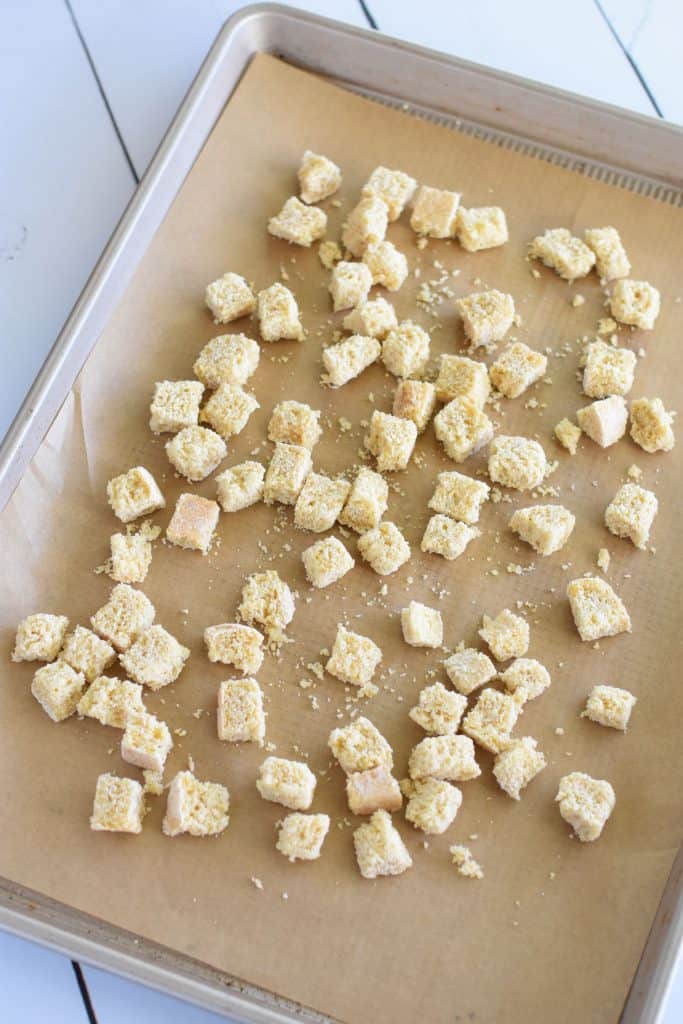 bread cubes on parchment-lined baking sheet before toasting in oven