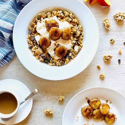 air fryer bananas on top of a bowl of granola with yogurt