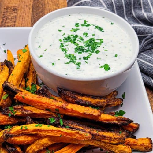 carrots on white plate with side of Greek yogurt dip