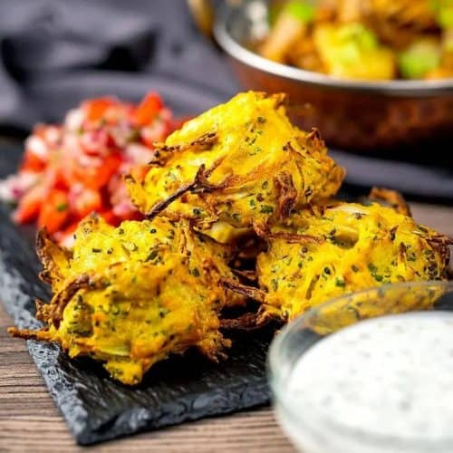 onion Bhaji with side of dipping sauce toward the front