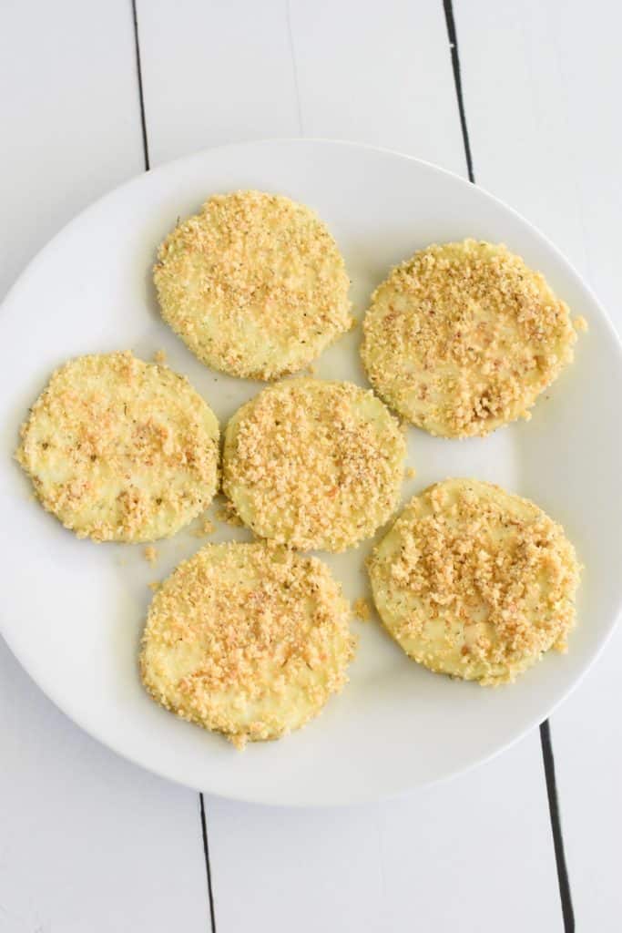 breaded eggplant slices on a white plate