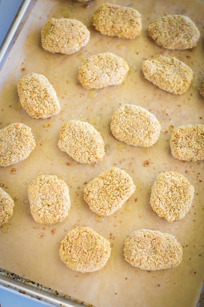 nuggets on parchment-lined baking sheet after cooking