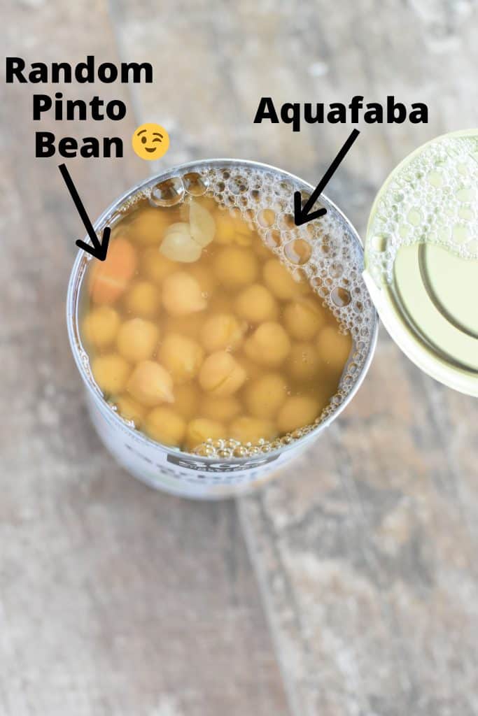 overhead of open can of chickpeas with text and arrow showing aquafaba.