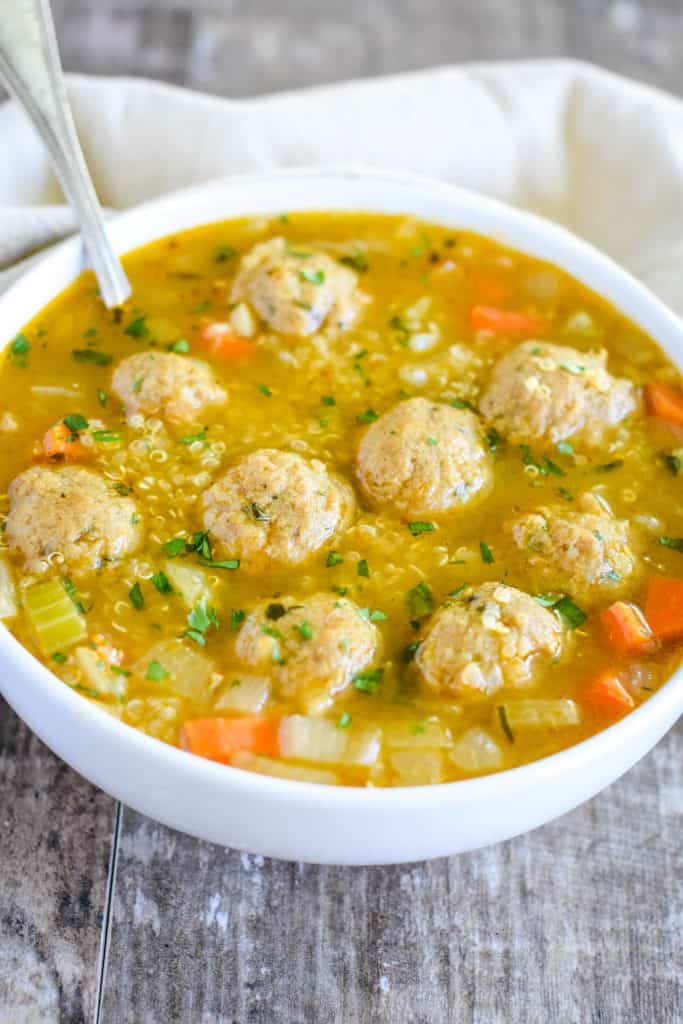 slight overhead of soup in white bowl with spoon in it