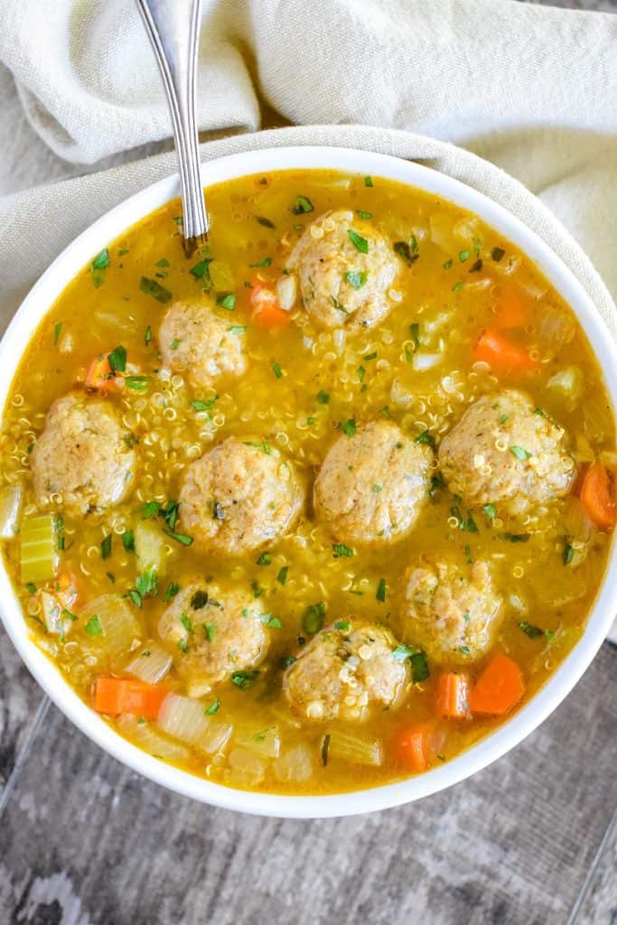 overhead of soup in a white bowl with spoon in it at the top