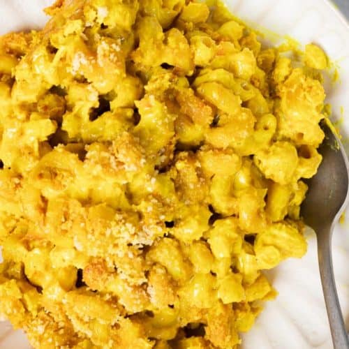 overhead of baked mac and cheese on a white plate with a fork.